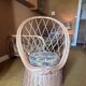 Vintage shell chair in woven rattan with original cushion.
