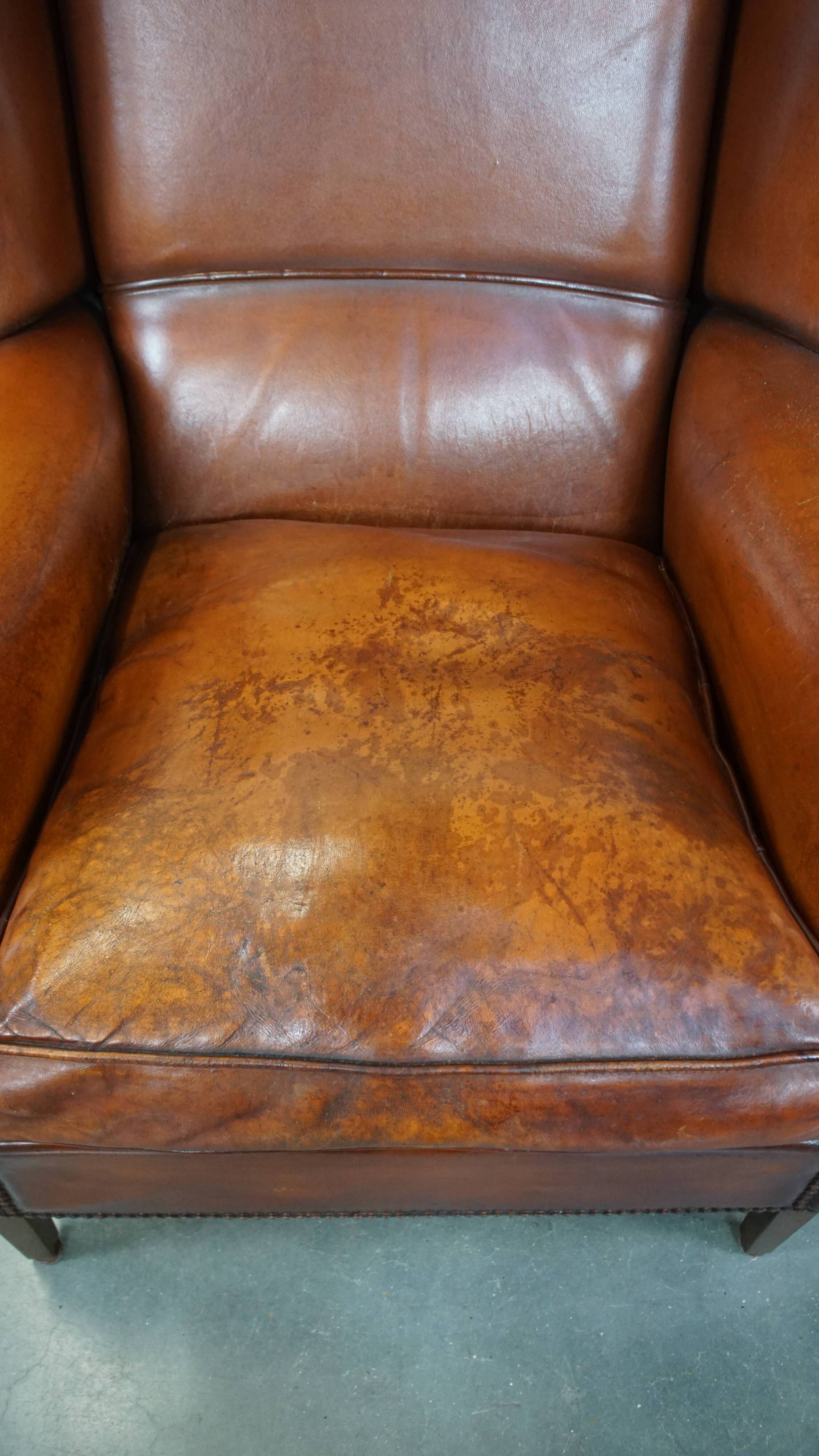 Sheepskin leather wingback chair with patina