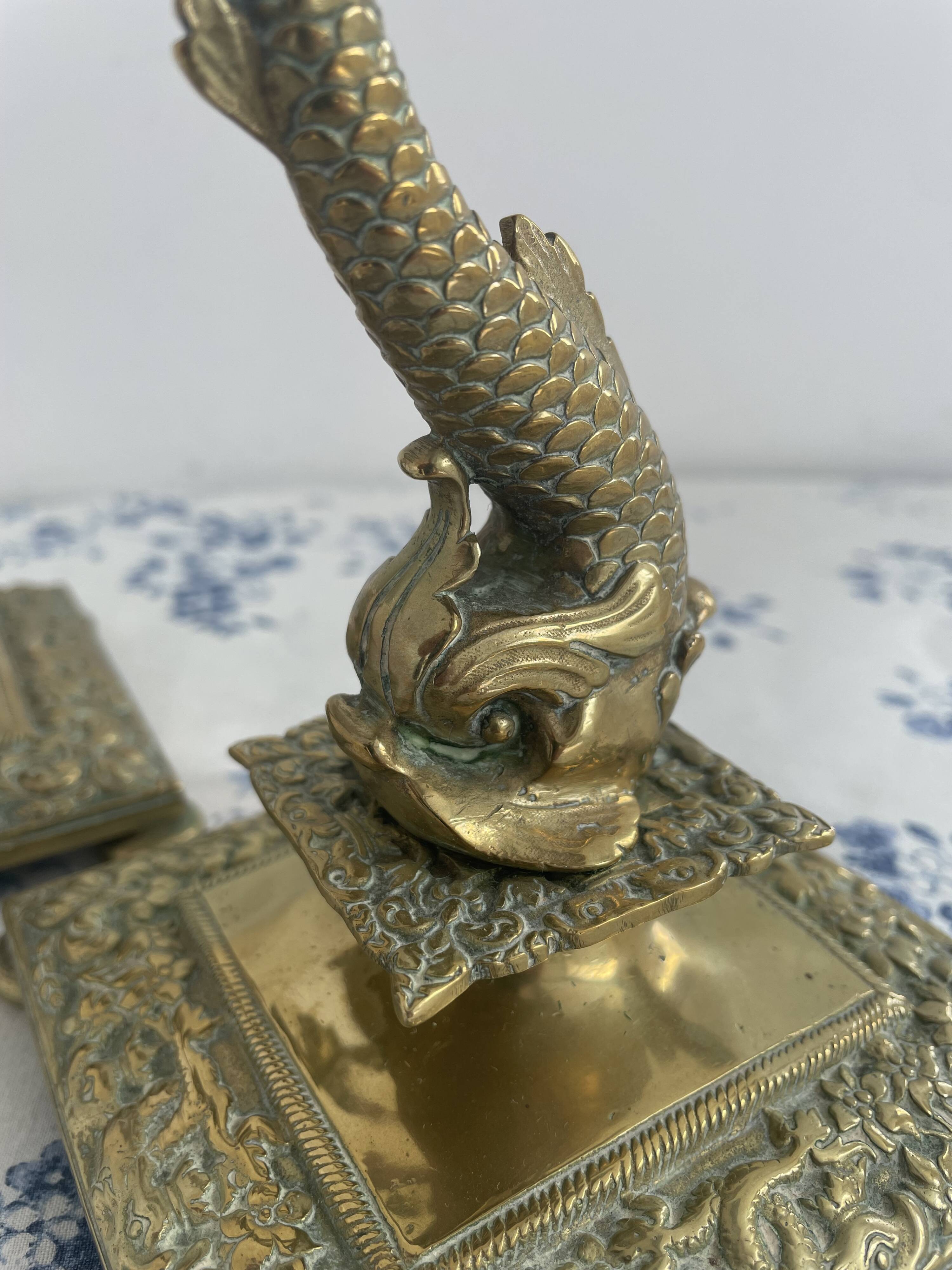 Pair of brass dolphin candlesticks, late 19th century, Napoleonic period