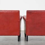 Set of 2 red-colored design armchairs made of sheepskin leather