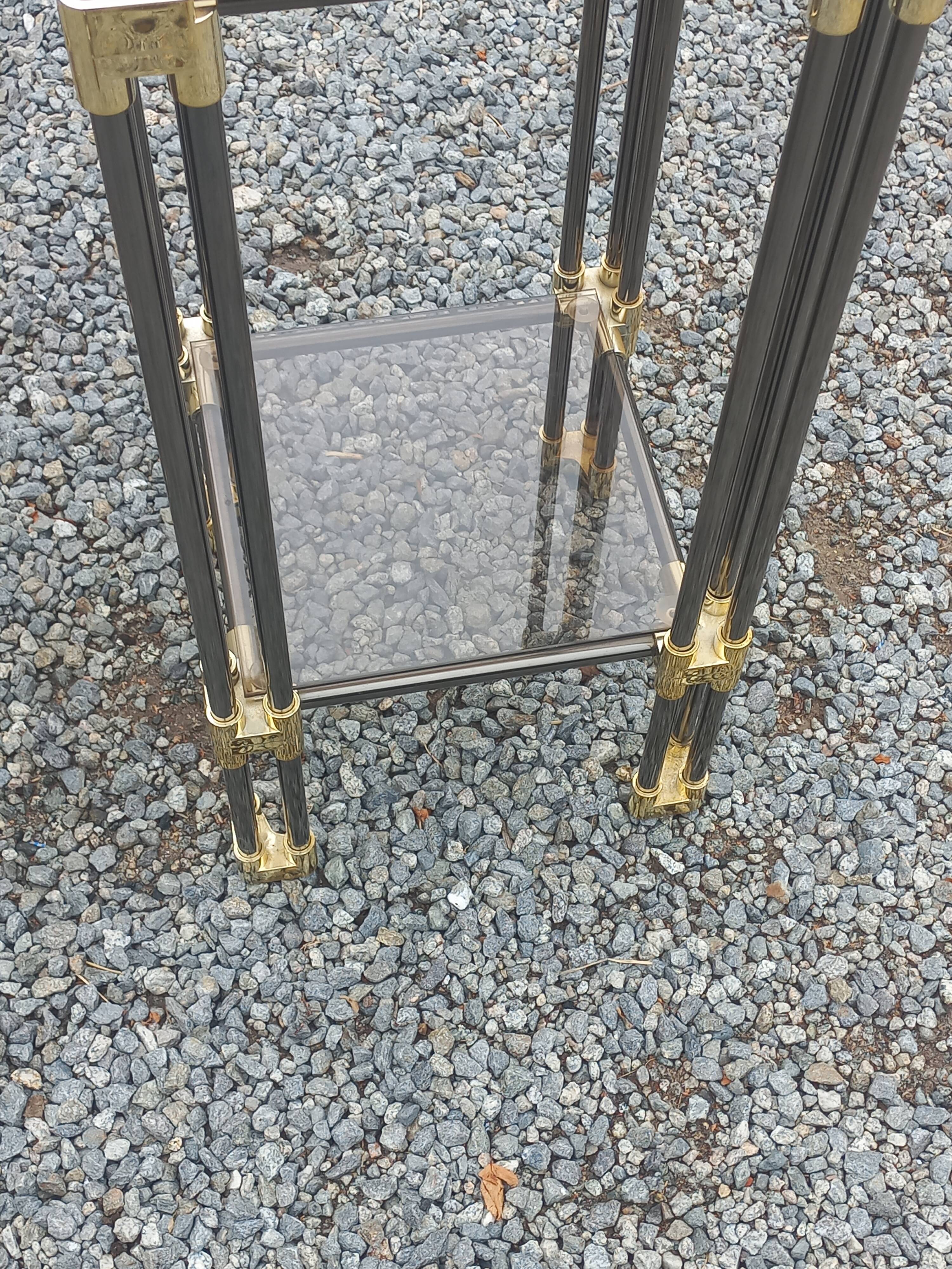 Pair of Hollywood Regency side tables in gold metal and smoked glass.