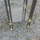 Pair of Hollywood Regency side tables in gold metal and smoked glass.