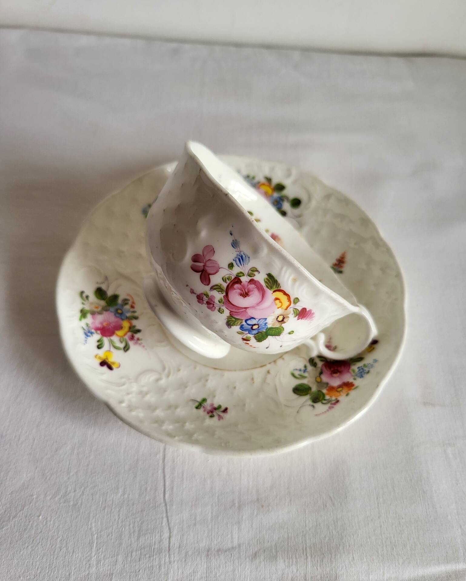 Antique Cup and Saucer in Porcelain with Hand-Painted Floral Decoration