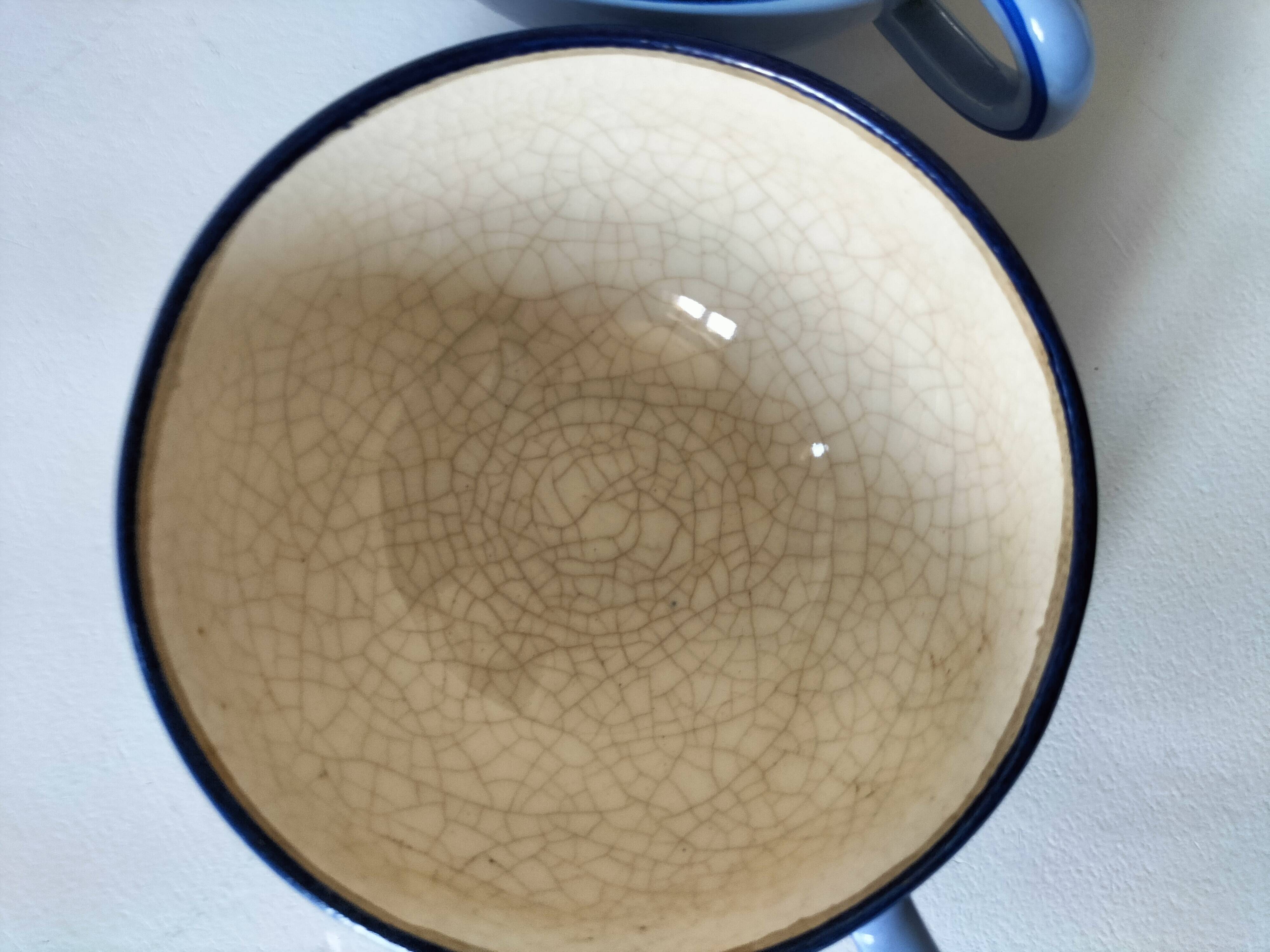 A pair of glazed ceramic cups and saucers from the 60s-70s.
