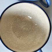 A pair of glazed ceramic cups and saucers from the 60s-70s.