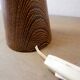 Wooden table lamp in the shape of a bowling pin with a bamboo shade from the 1960s.
