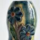 Very colorful glazed earthenware vase, old vase with floral decoration.