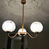 antique chandelier has 3 globes