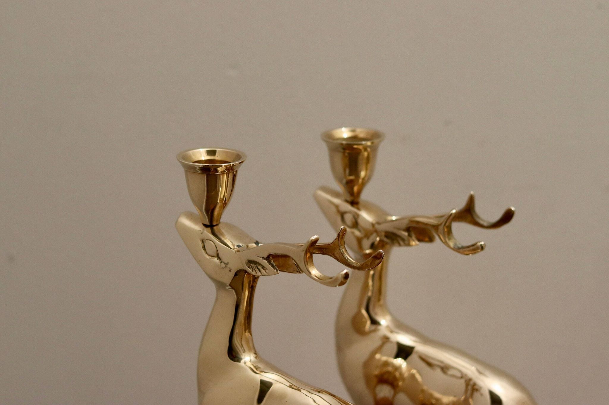Pair of brass candle holders in the shape of deer from the mid-century.