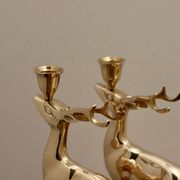 Pair of brass candle holders in the shape of deer from the mid-century.
