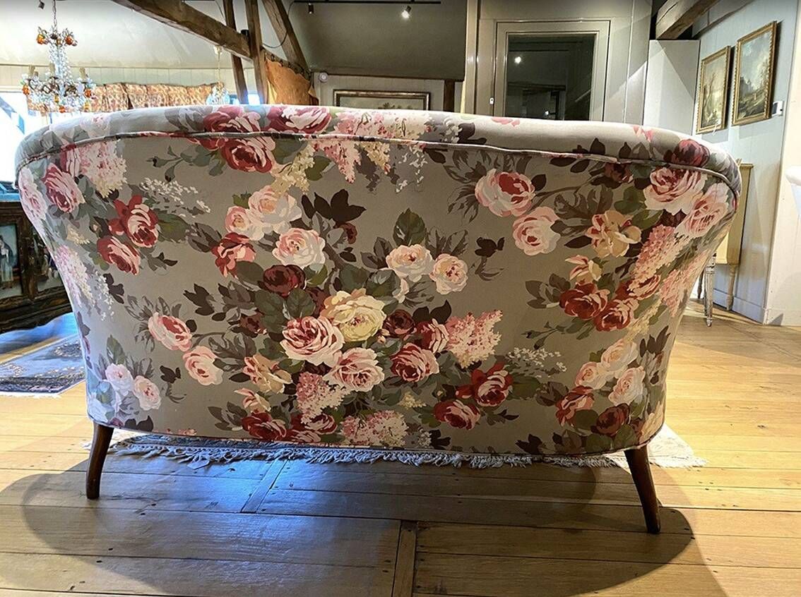 Set of two toad-shaped sofas covered in floral fabric.