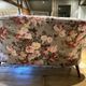 Set of two toad-shaped sofas covered in floral fabric.