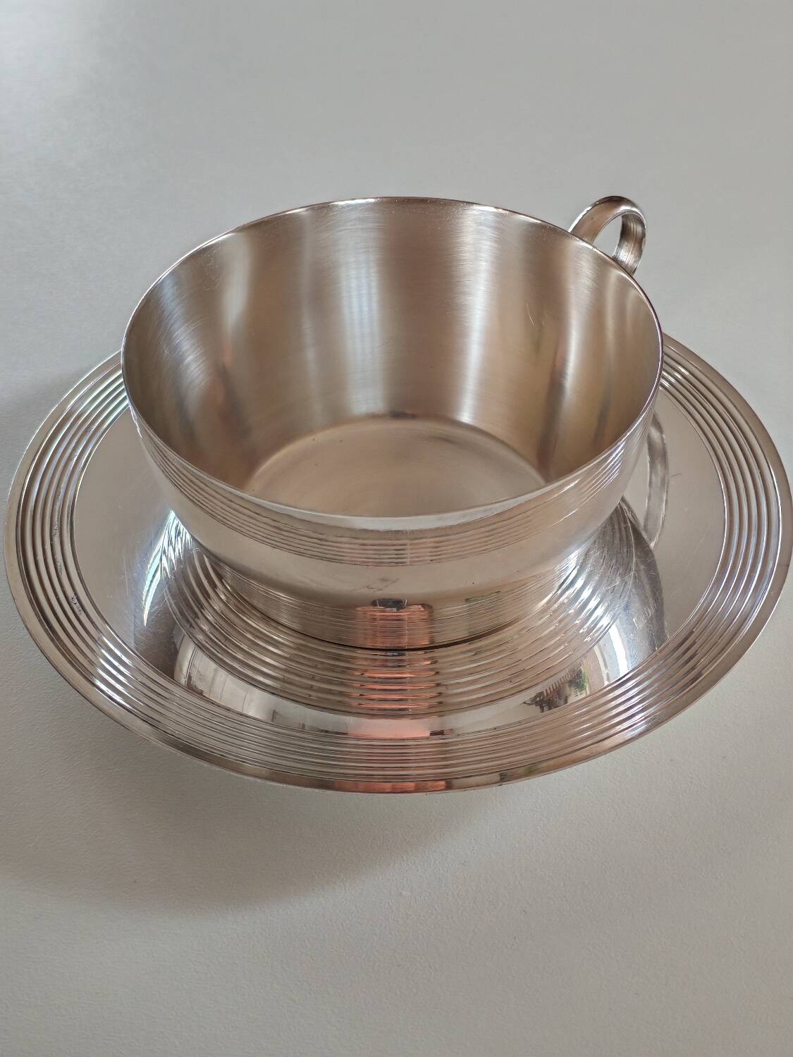 Silver-plated metal cup and saucer