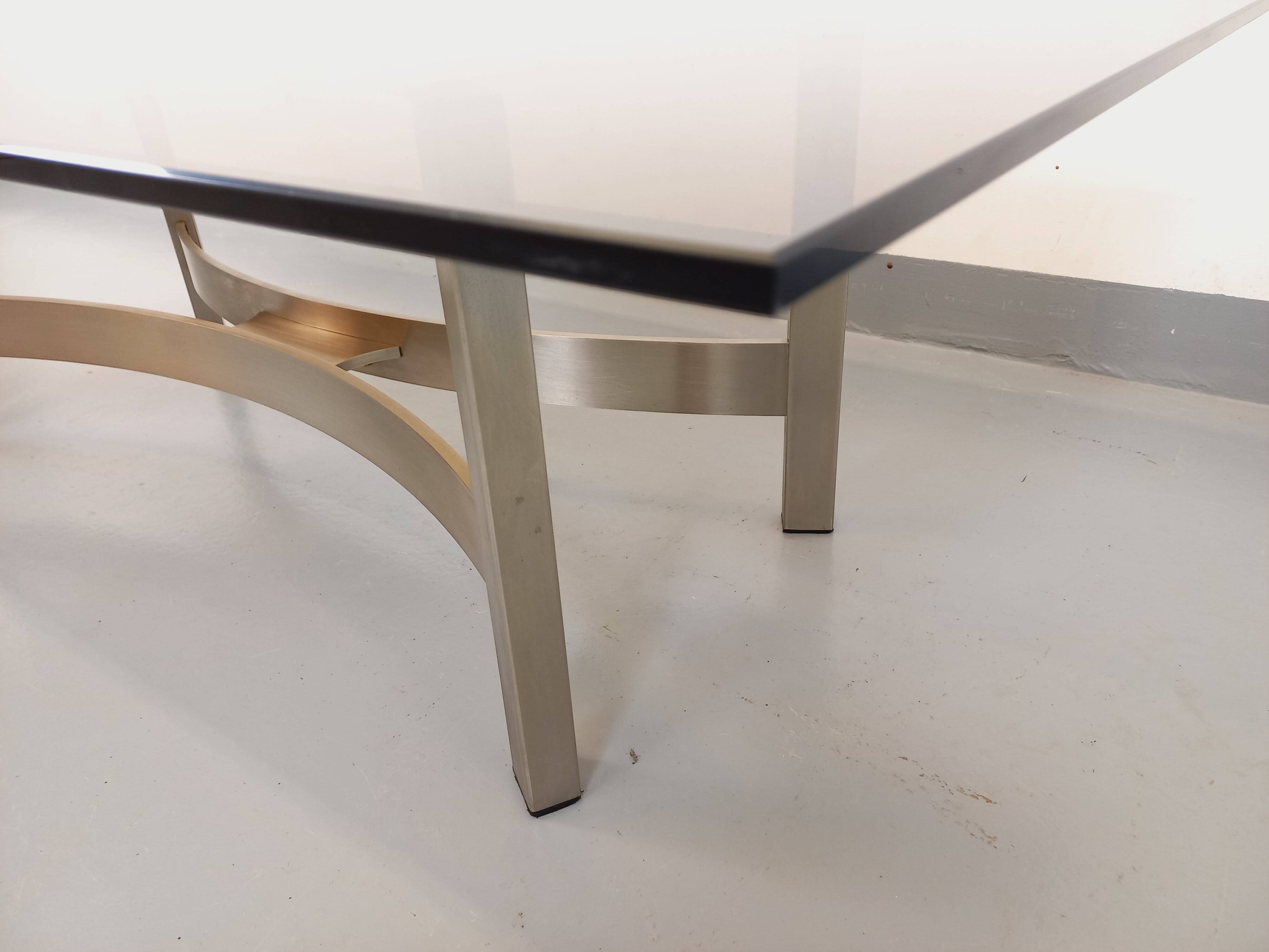 Vintage coffee table in smoked glass and brushed cast aluminum from the 70s