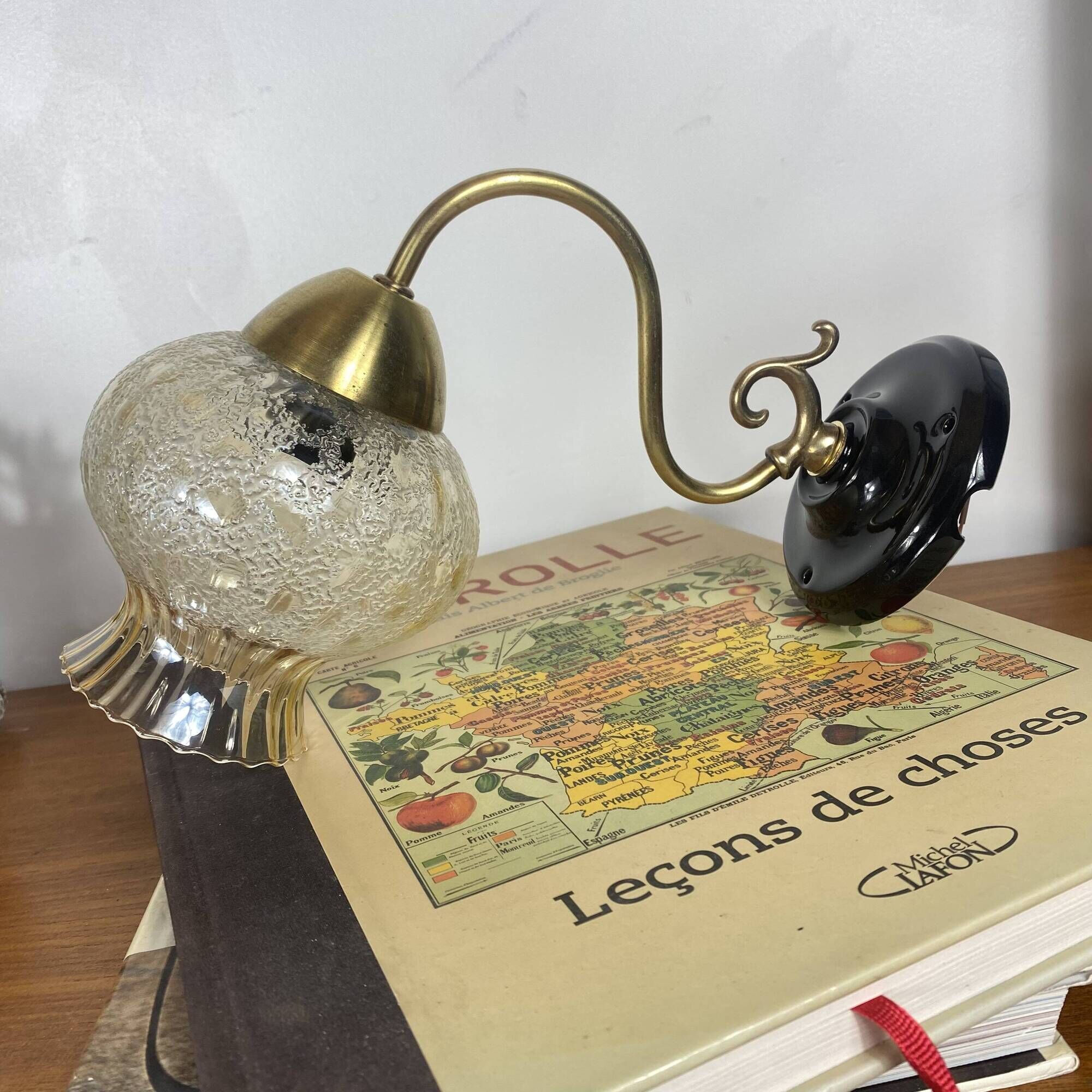 Pair of antique wall sconces in brass with tulip-shaped glass shades.