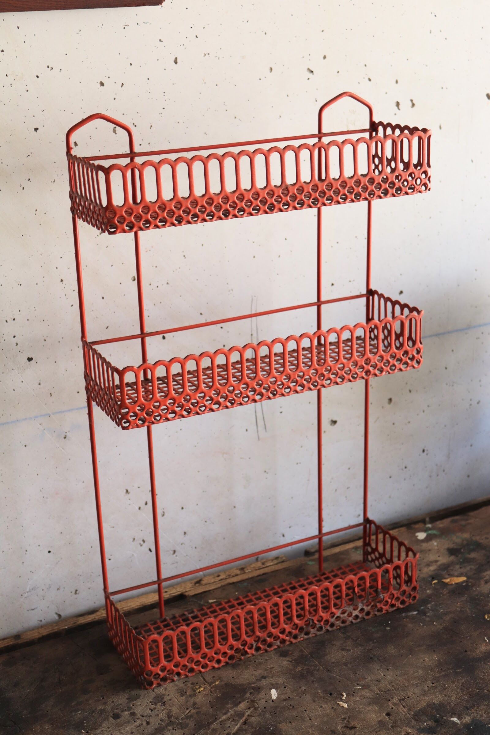 Vintage shelf in red openwork metal