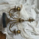 Pair of Empire style candlesticks, patinated brass and black stone.