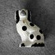 Vintage ceramic figurine from Staffordshire depicting a spaniel dog, England.