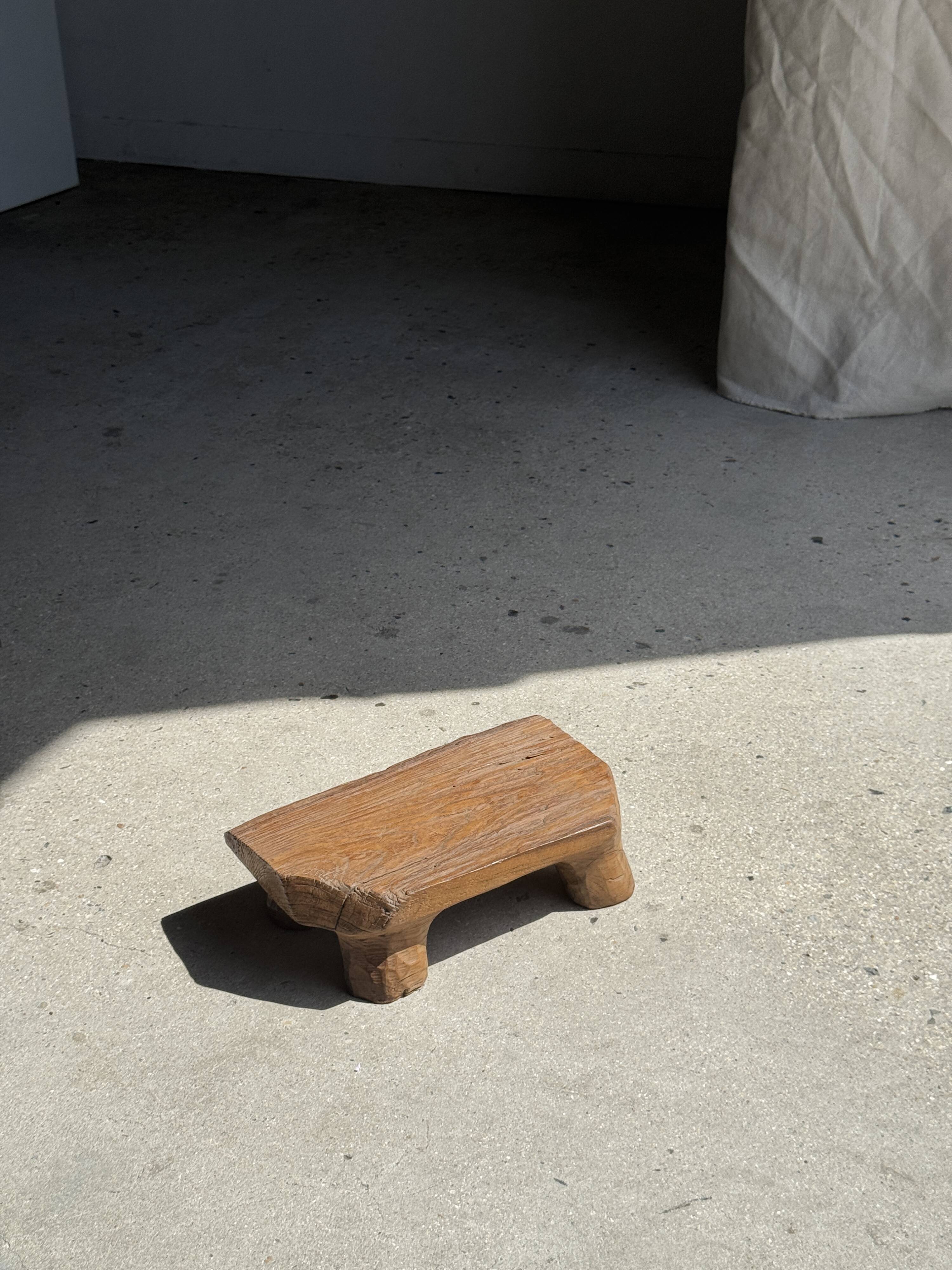 Small stool, teak footrest with short cut corners.