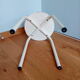 Industrial tubular metal stick sitting round in wood