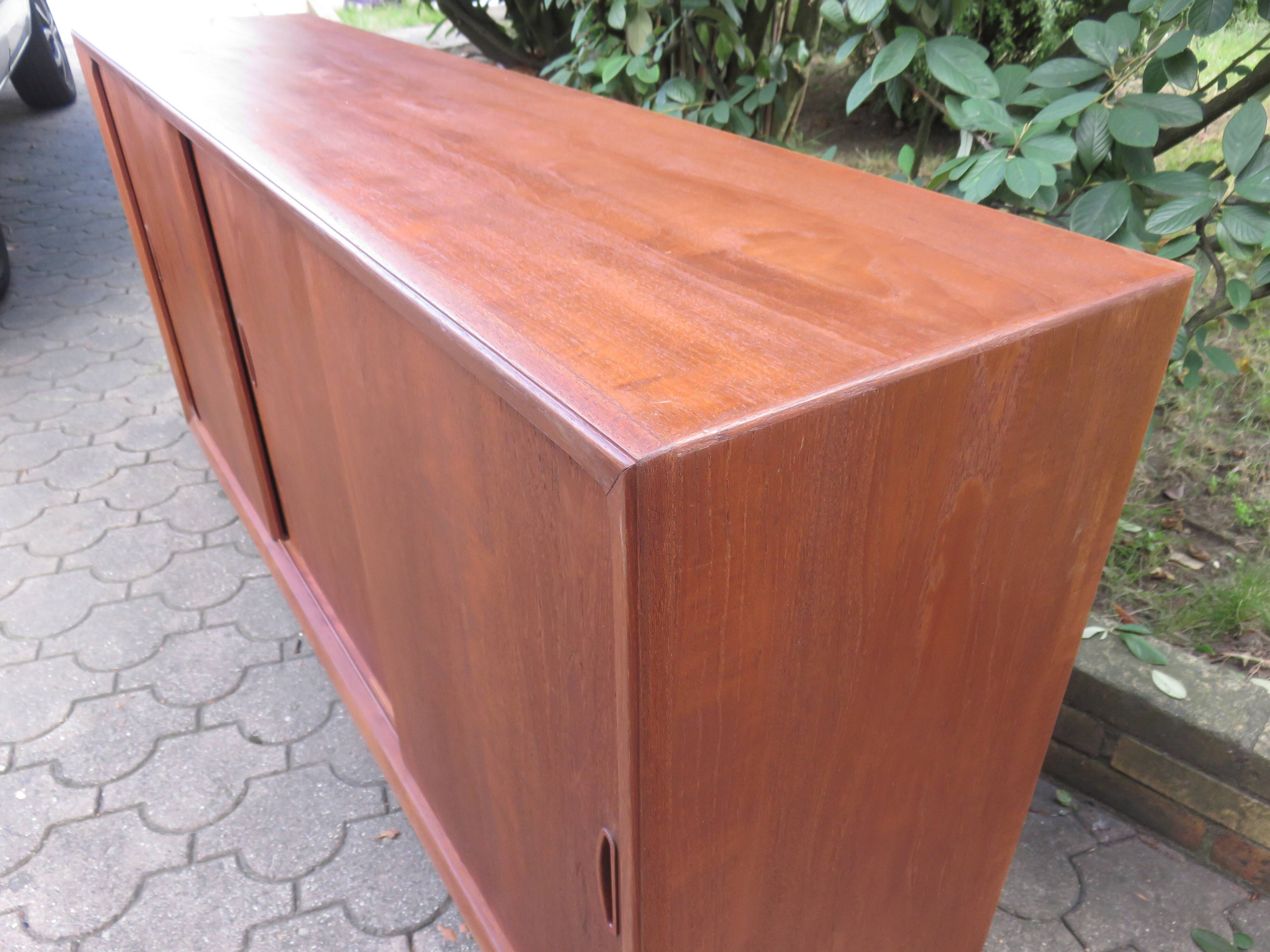 Low sideboard with 3 sliding doors in teak. Denmark 1960