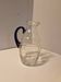 Glass carafe with wavy body and blue handle