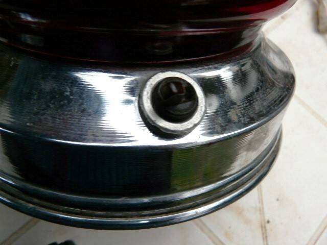 Red glass table lamp on a chrome base.