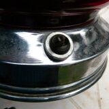 Red glass table lamp on a chrome base.