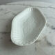 Oval white porcelain ramekin — raised floral pattern