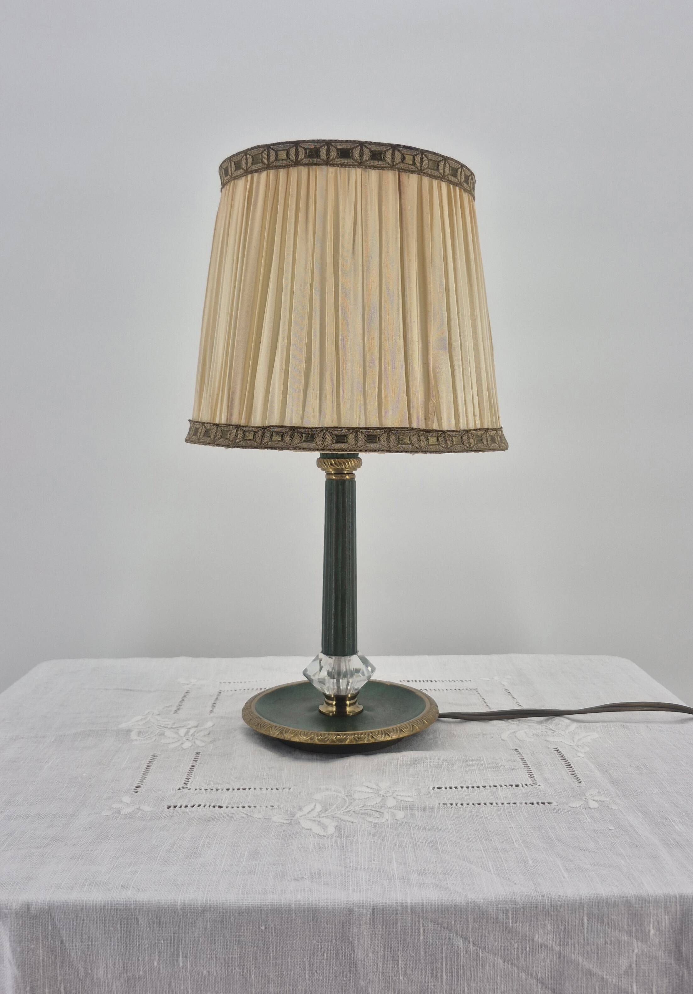 Brass table lamp with green patina and empire-style fabric shade.