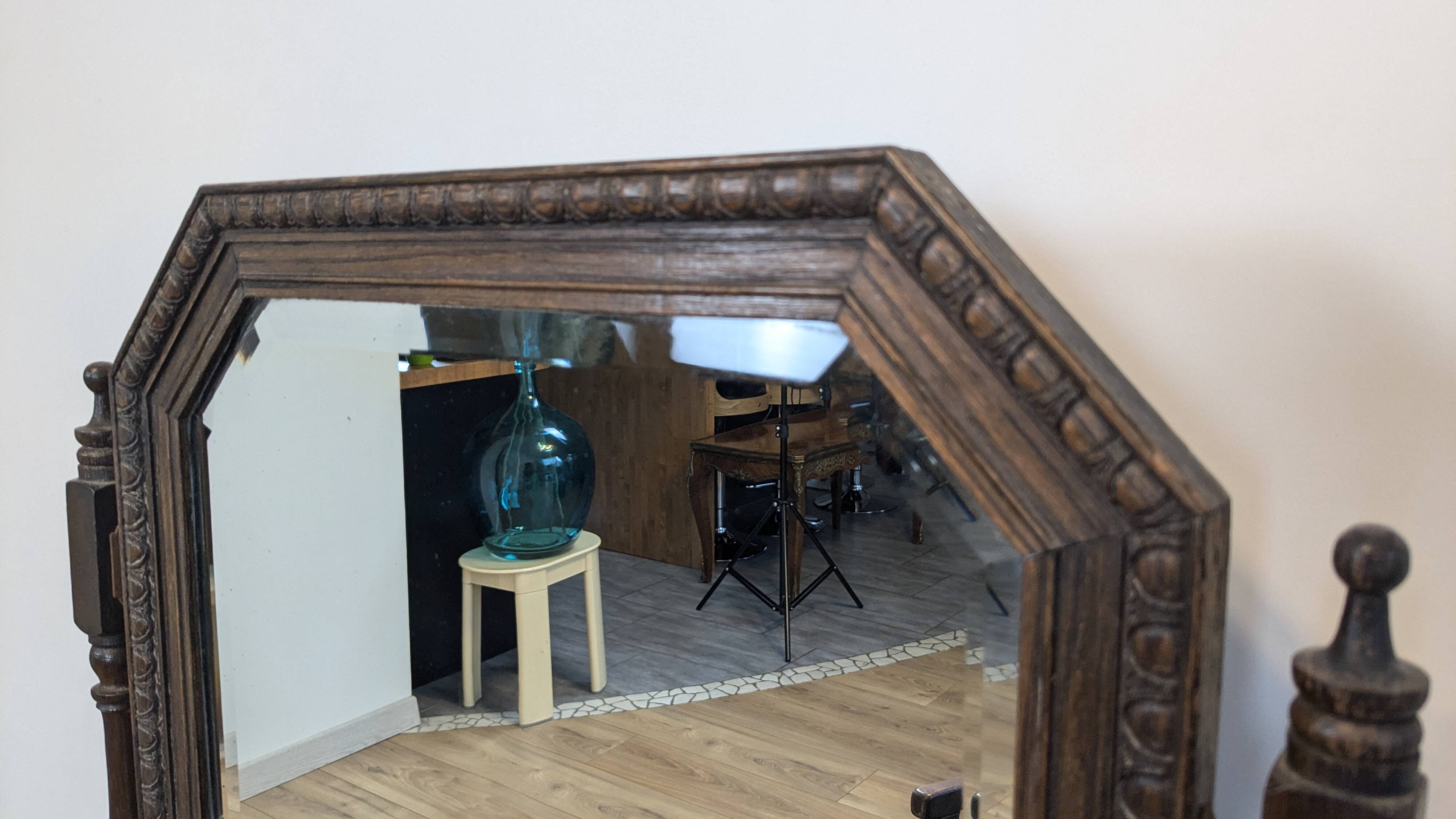 Antique beveled octagonal vanity mirror in carved wood