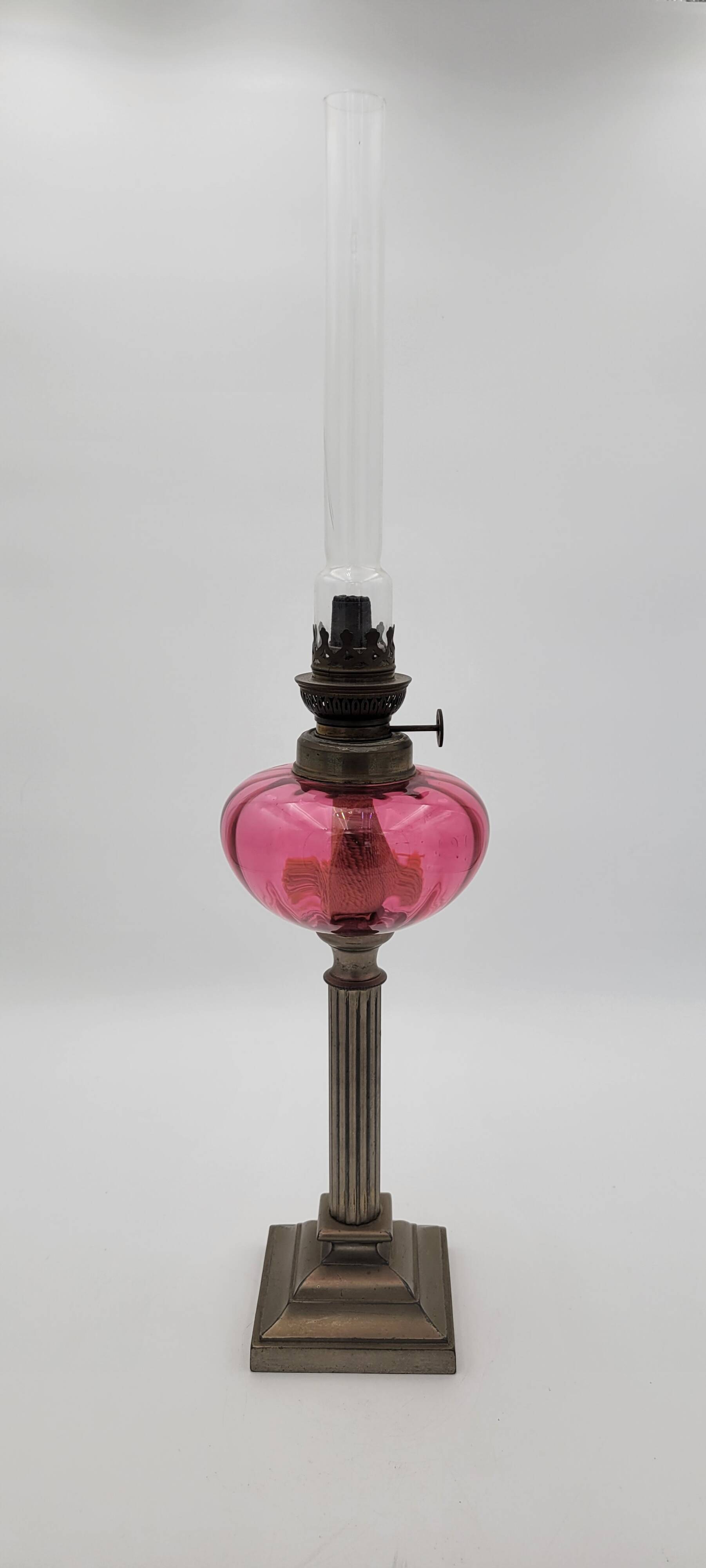 Old metal and pink glass oil lamp