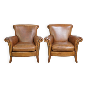 Set of 2 comfortable vintage sheepskin armchairs, finished with decorative nailheads