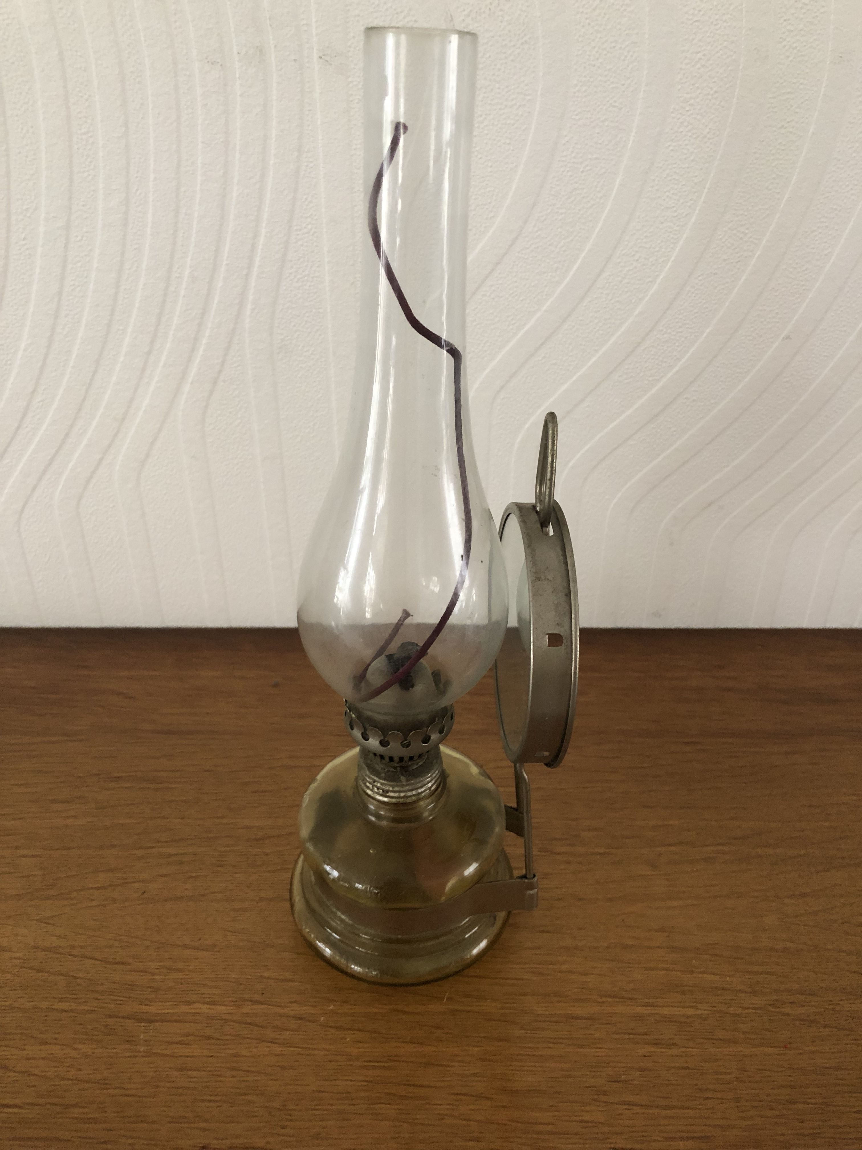Oil lamp with glass pedestal and integrated round mirror
