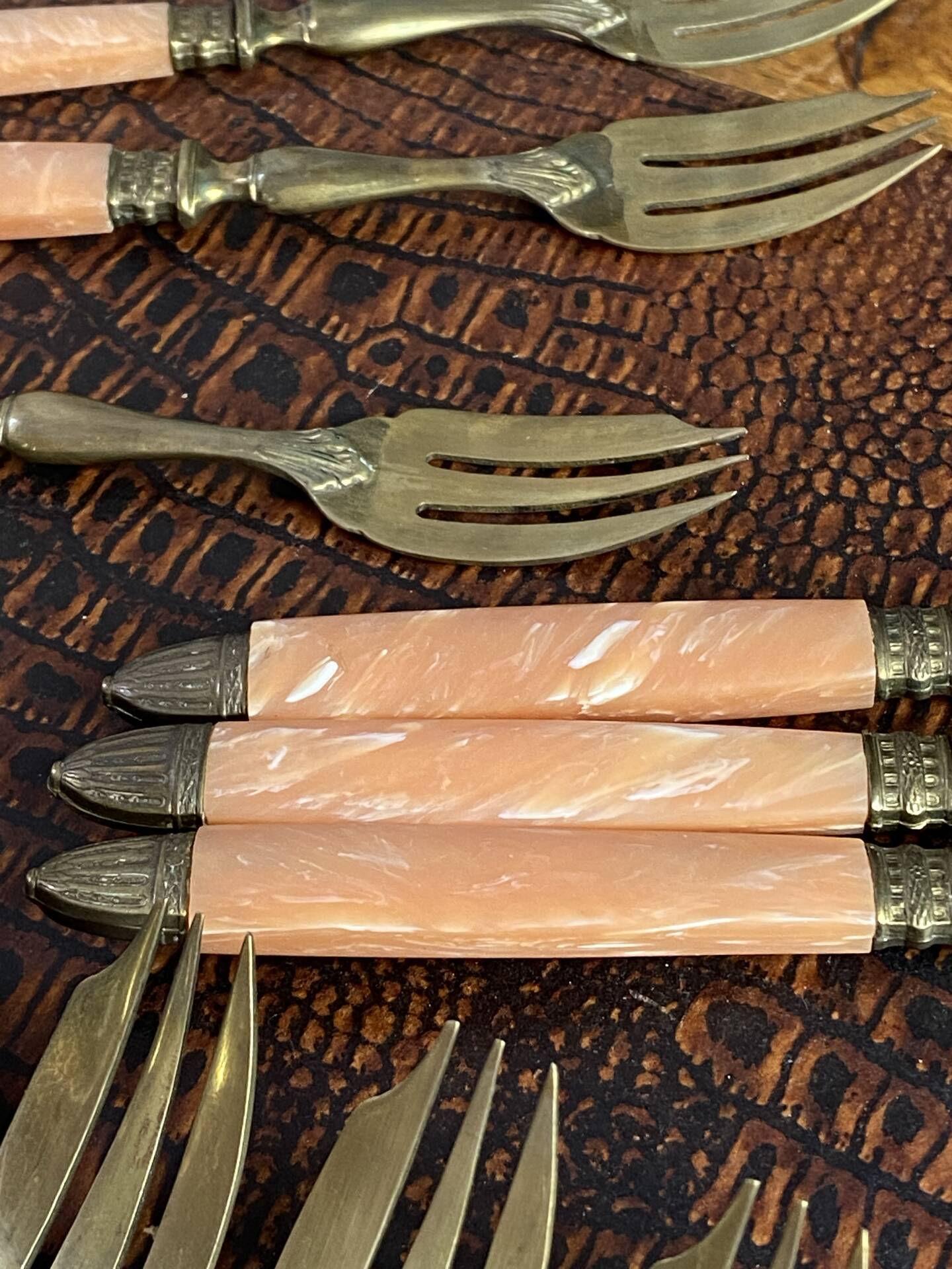 Dessert forks in brass and Bakelite in their case.