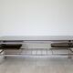 Chrome metal coffee table with smoked glass top.