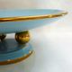 Art Deco modernist coupe, with a base of 3 spheres, in turquoise ceramic and gilding.