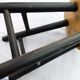 Low wooden stool and black patina