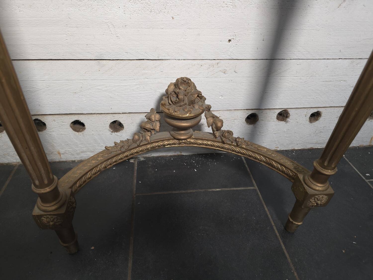Louis XVI style console in gilded wood with a marble top.