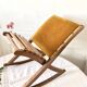 Old wooden rocking footrest with velvet fabric