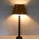 turned wooden lamp with spool base and vintage copper shade