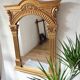 Miroir en bois doré a fronton travaillé