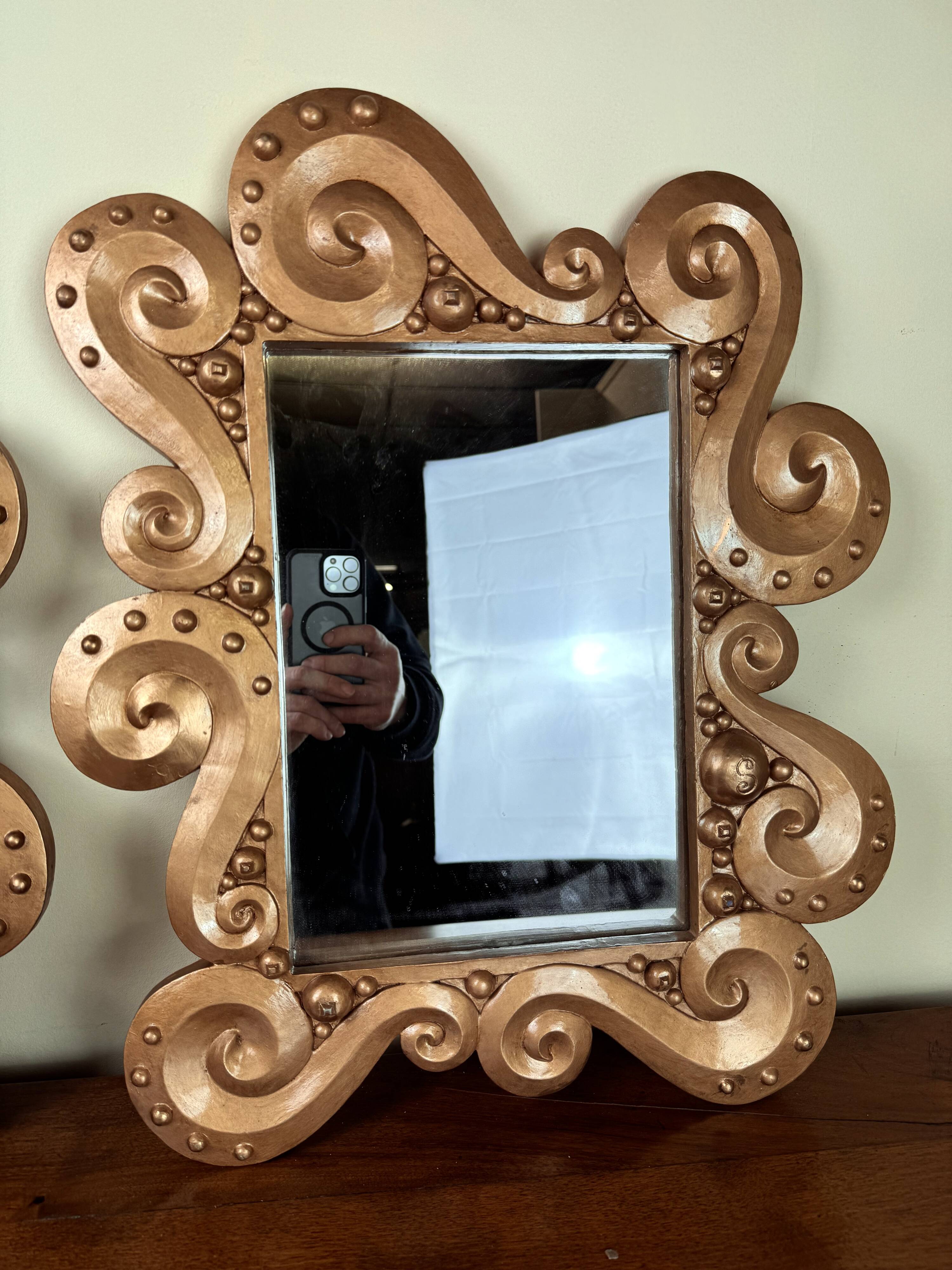 According to the model “the waves” by Jean Boggio: pair of designer gold mirrors circa 1980