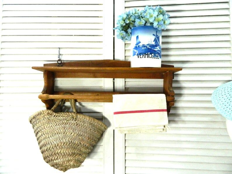 Wooden shelf with hooks and towel holders