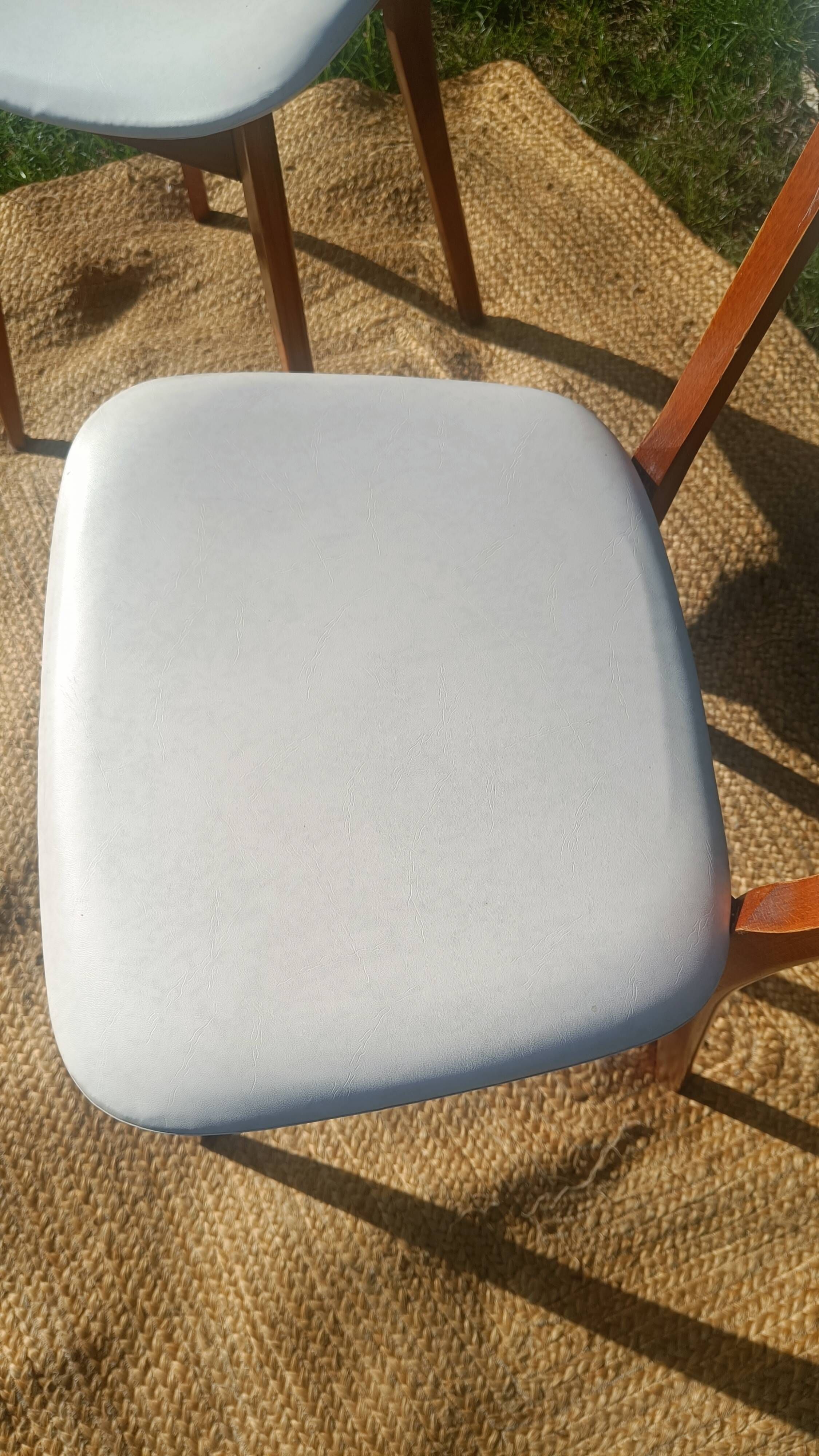 vintage wooden chairs with white faux leather