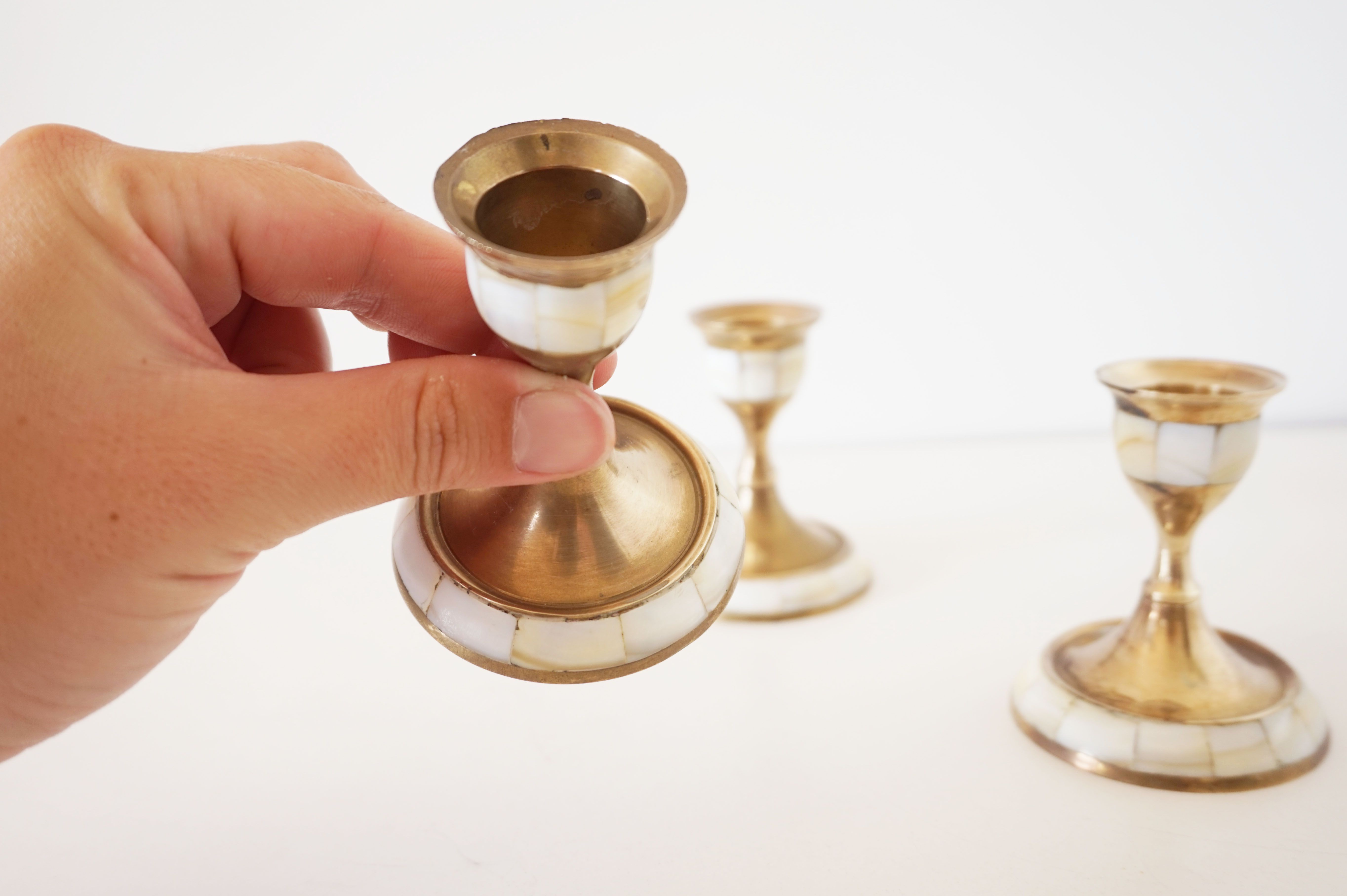 Lot of old candlesticks in brass and mother-of-pearl