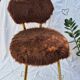 Vintage shaggy chair in faux fur with golden metal legs.