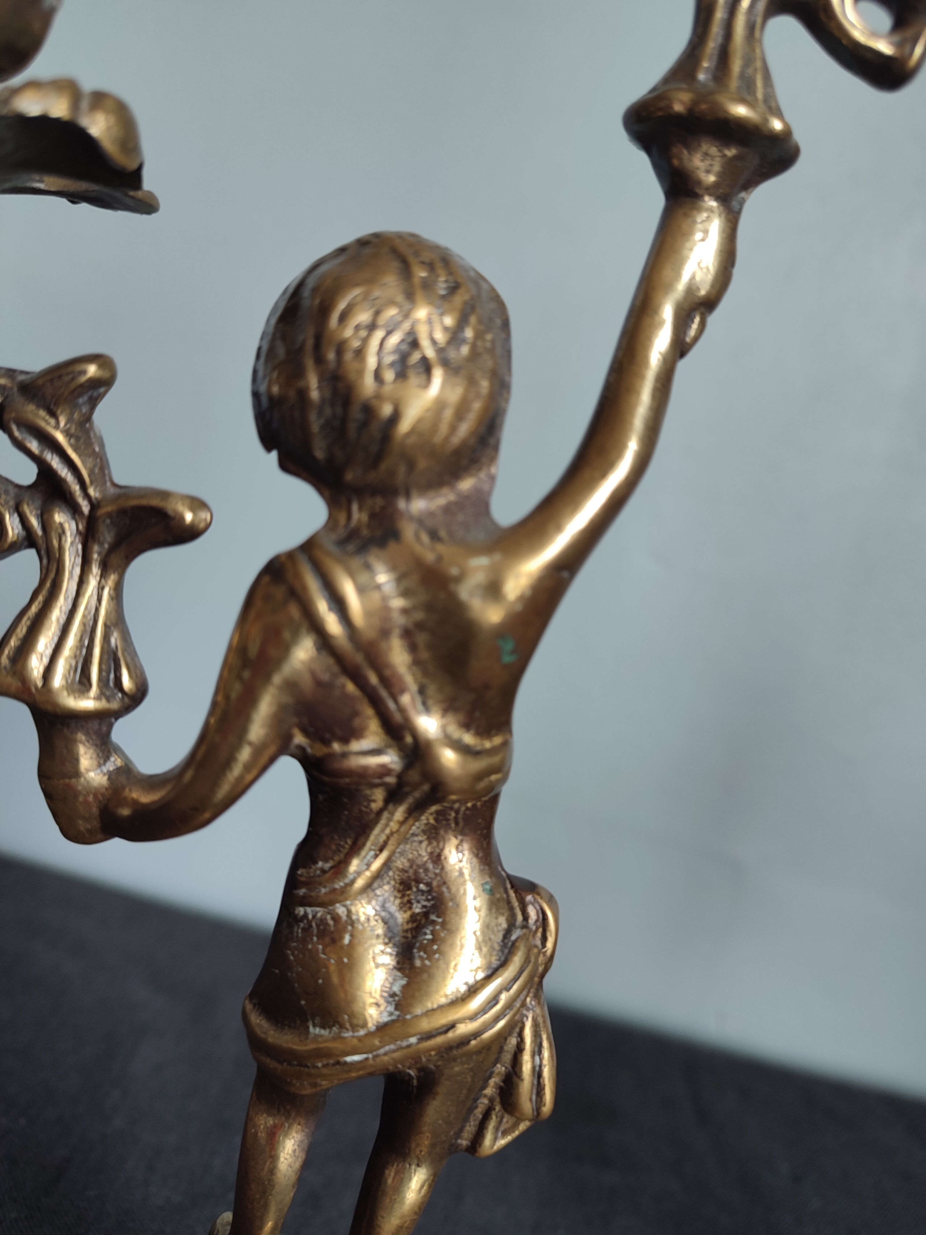 Pair of antique candlesticks in cherub bronze