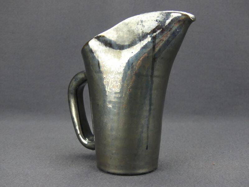 Old Biot, modernist pitcher in iridescent black ceramic.