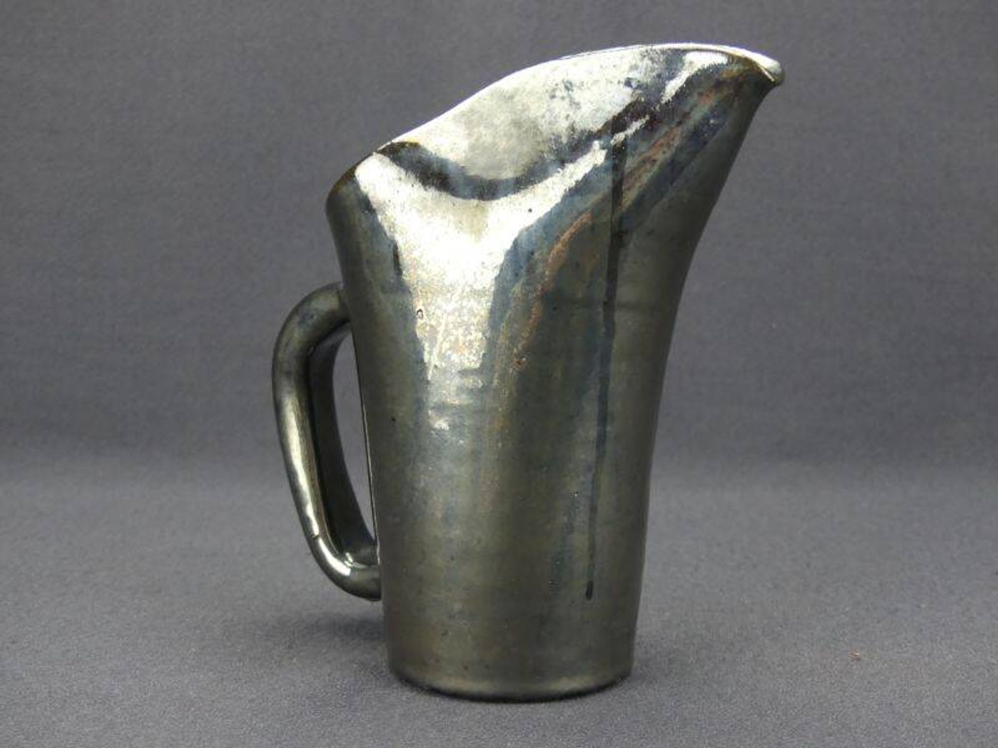 Old Biot, modernist pitcher in iridescent black ceramic.
